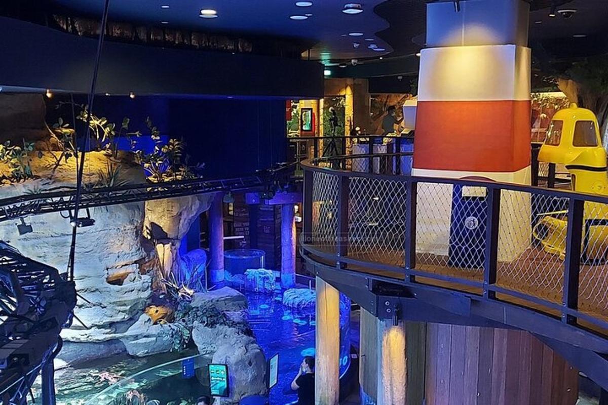 a large indoor aquarium with a boat in a building