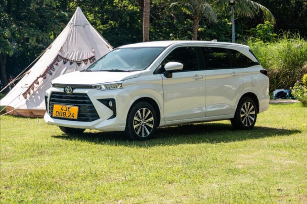 en hvit SUV parkert i et jorde med et telt