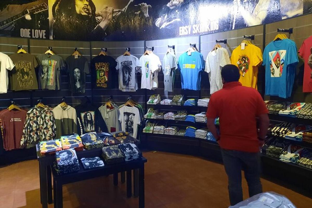 a man looking at a display of shirts in a store