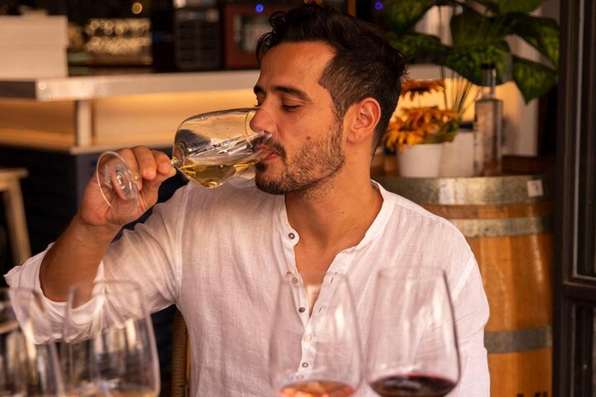 en mann som drikker av et glass vin