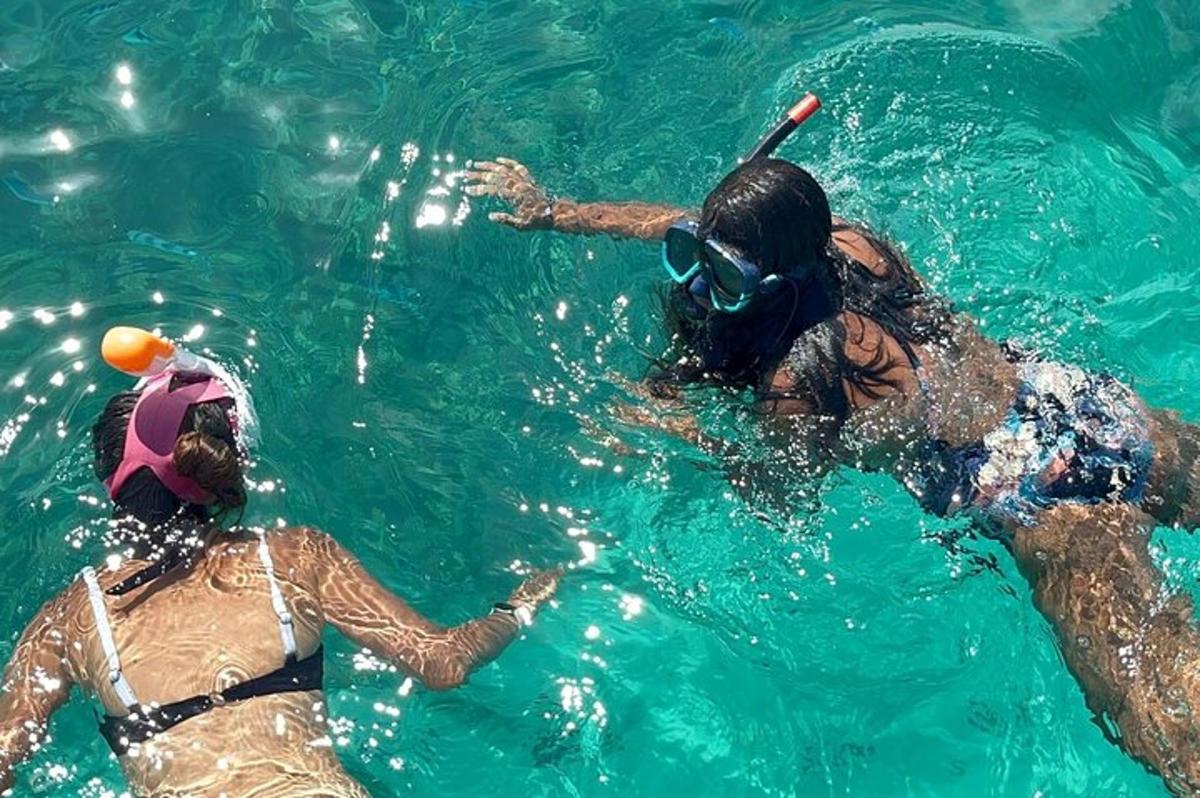 two people in the water playing with a ball