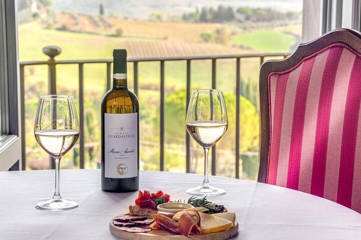 a bottle of wine sitting on a table with two glasses