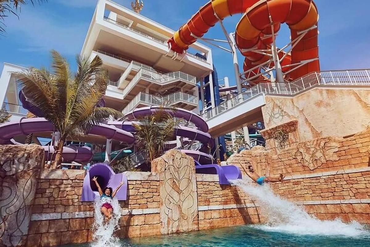 a girl riding a water slide at a water park