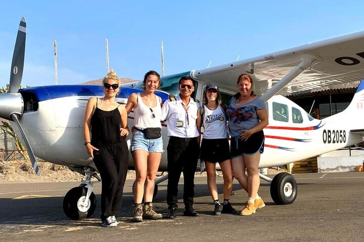 un gruppo di persone in piedi davanti a un aereo