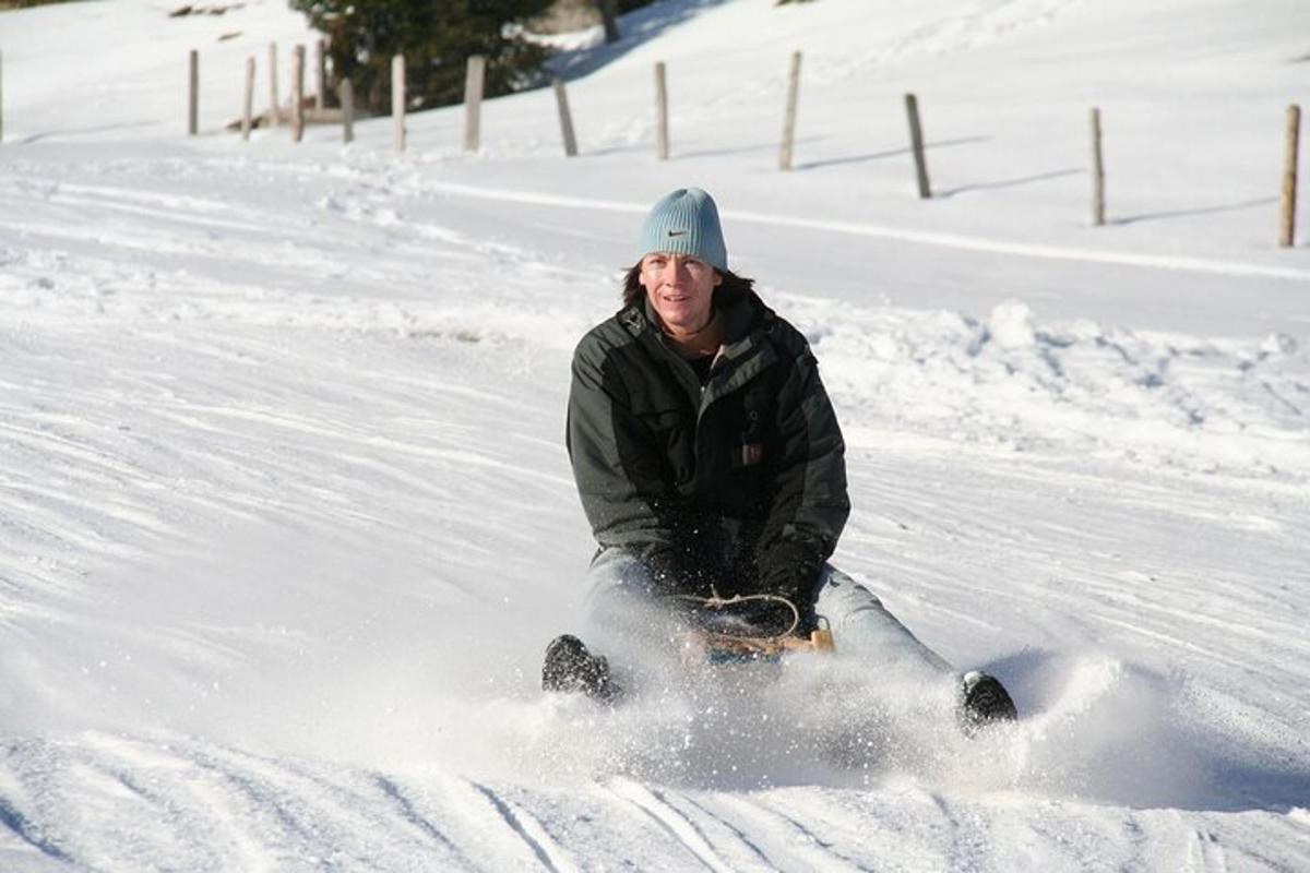 a man riding a snowboard down a snow covered slope
