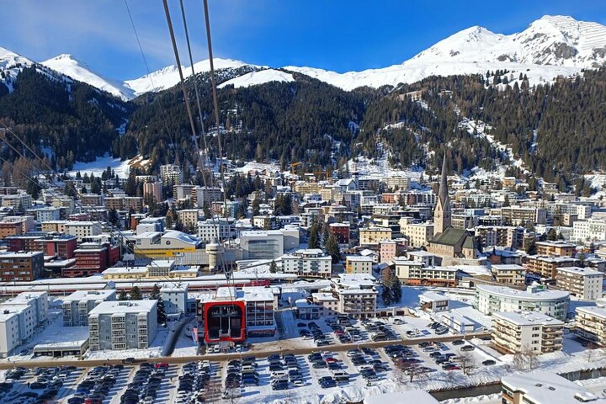 an aerial view of a city with snow covered mountains