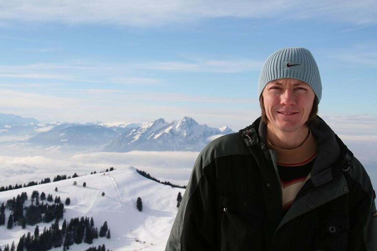 a man standing on top of a snow covered mountain