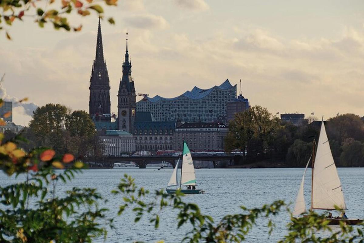 two sailboats on the water in front of a city