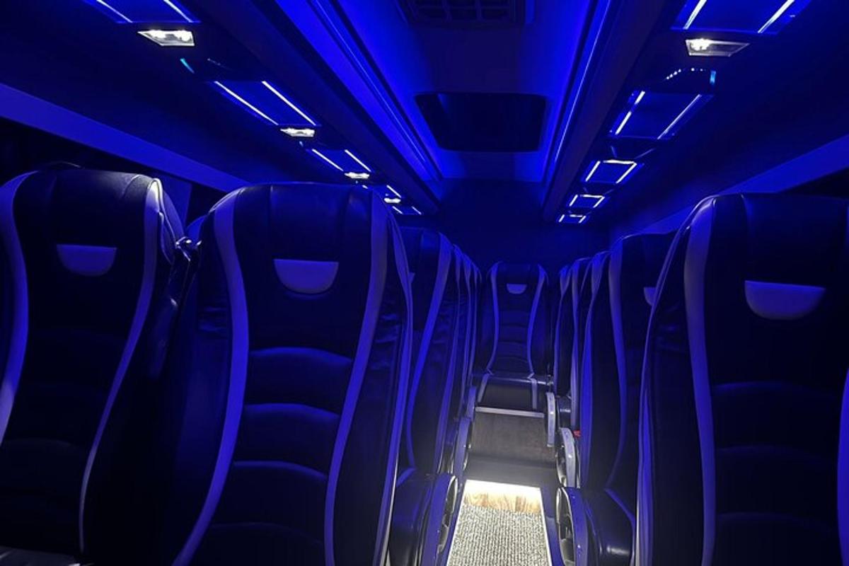 an empty bus with blue lights on the seats