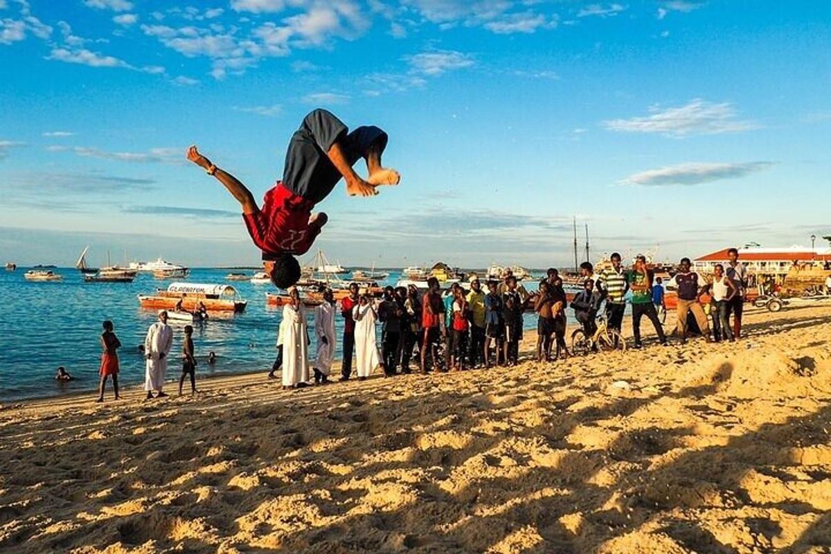 moški izvaja trik na plaži
