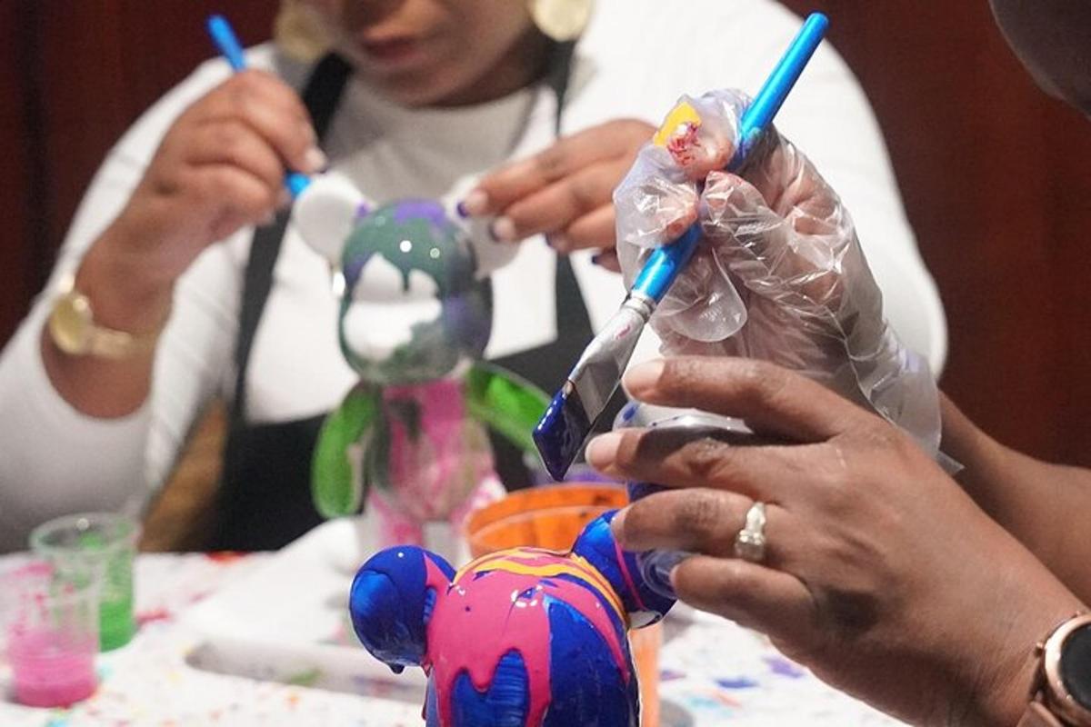 a group of people sitting at a table with tooth brushes