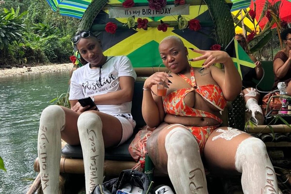 two women sitting on a raft in the water