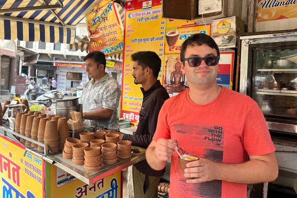 a man is standing in front of a food stand