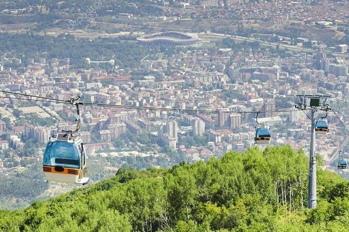 three cable cars are flying over a city