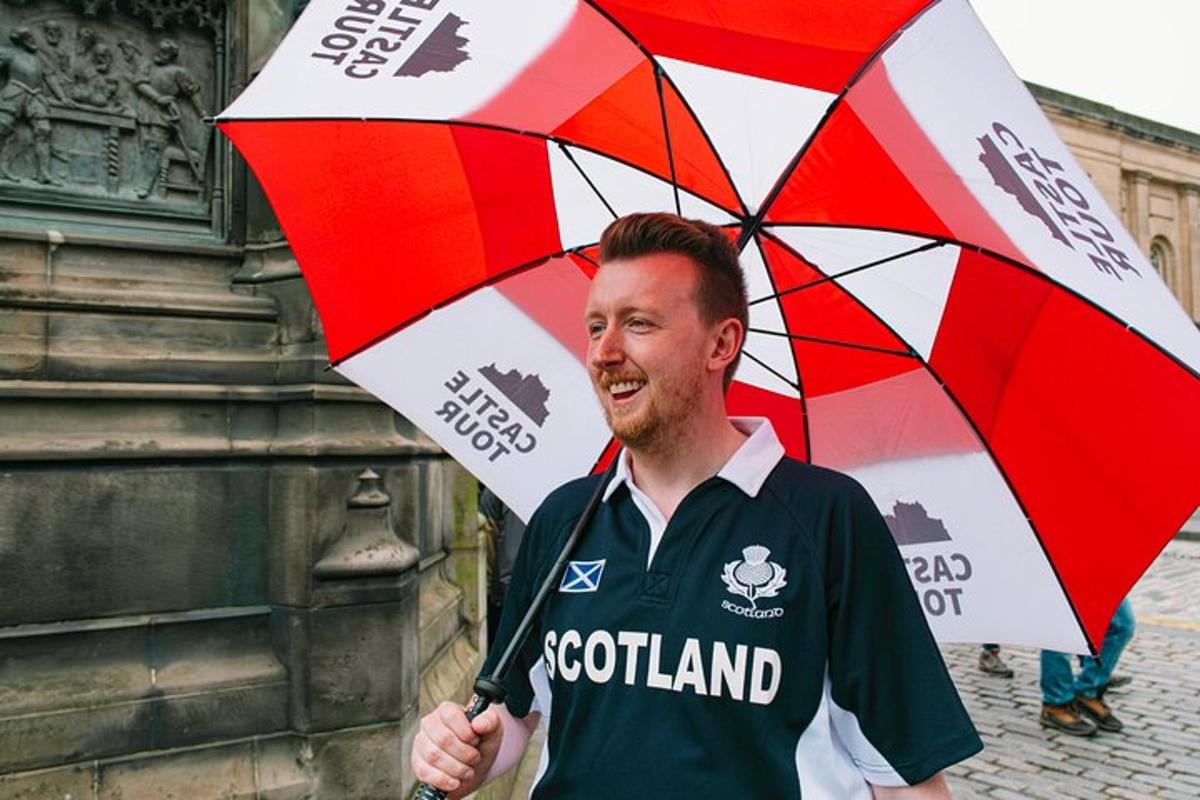 a man is holding a red and white umbrella