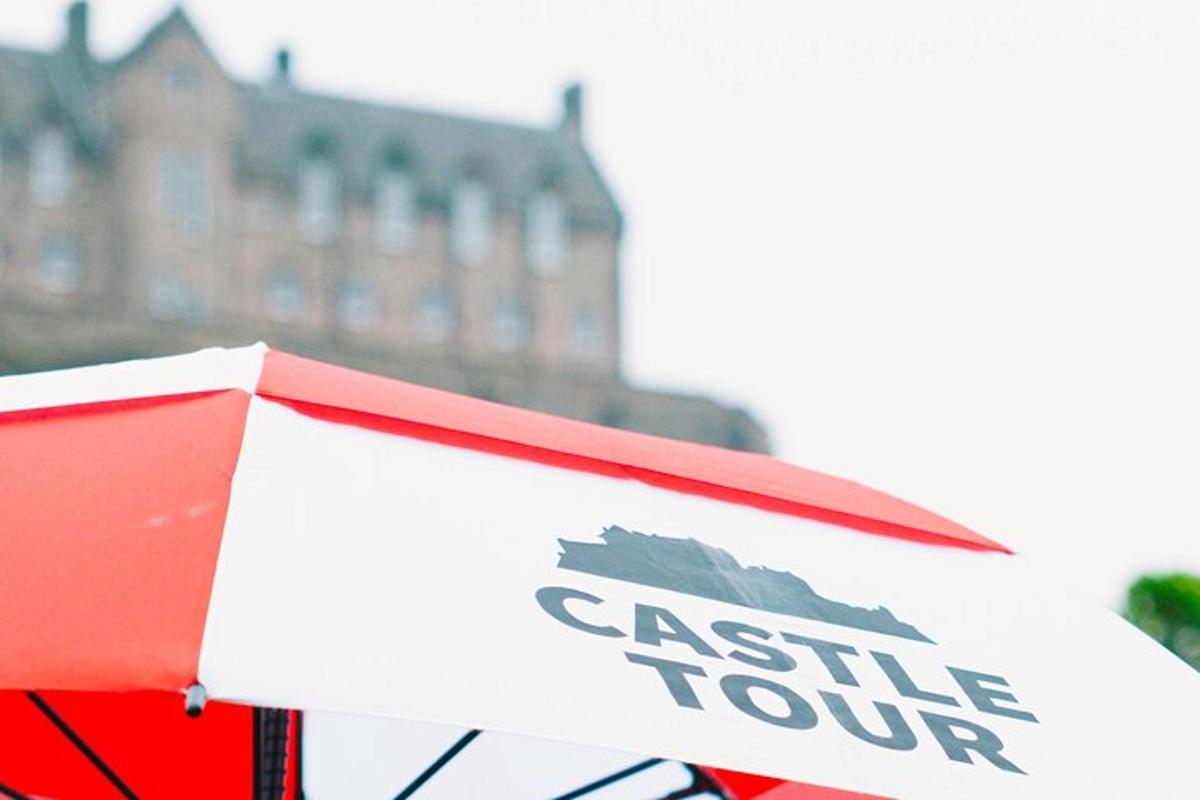 a red umbrella with the words elite tour on it