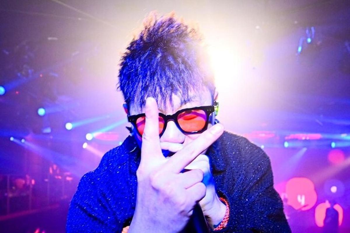 a man holding up his peace sign with his hand