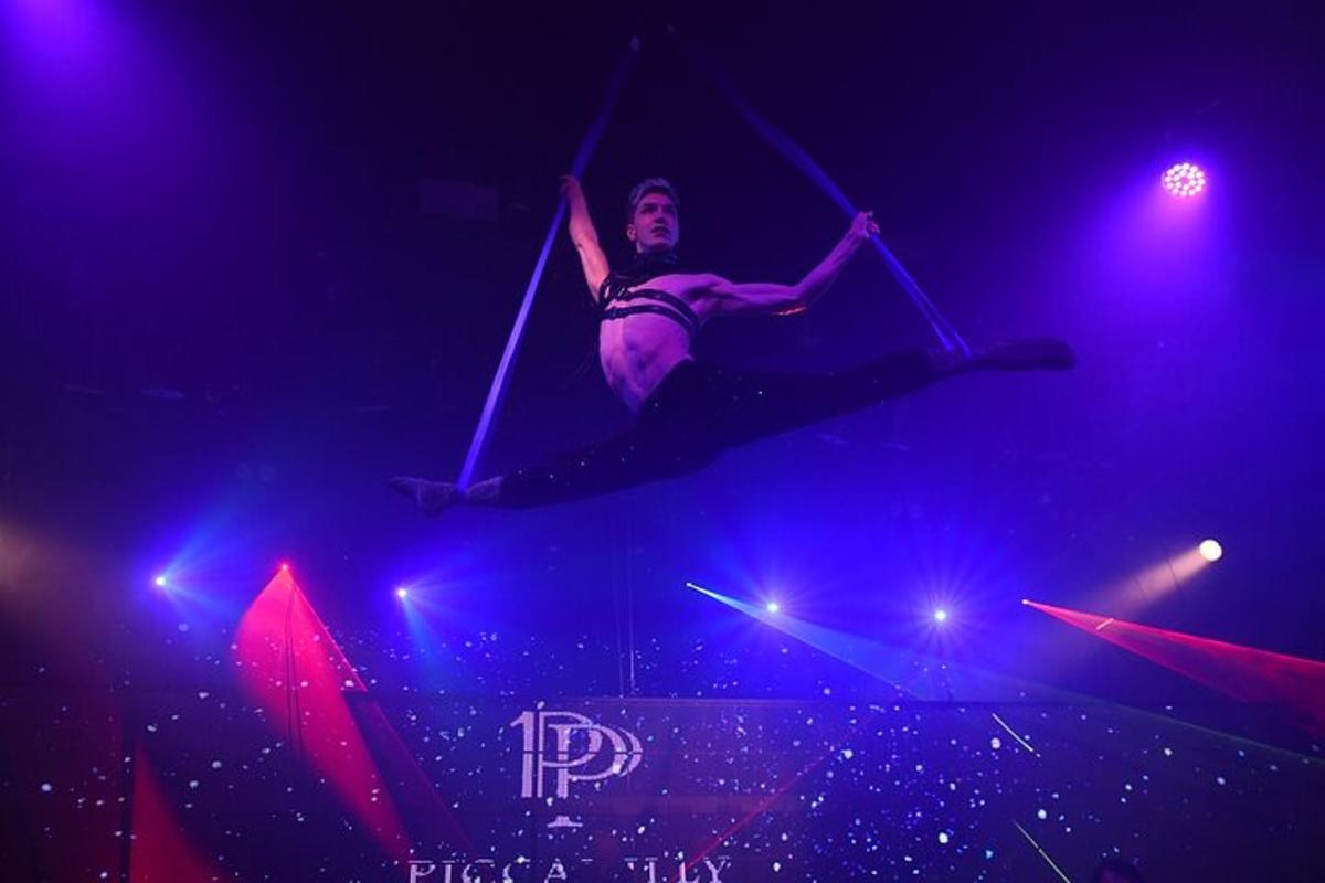 a woman is jumping in the air on a circus