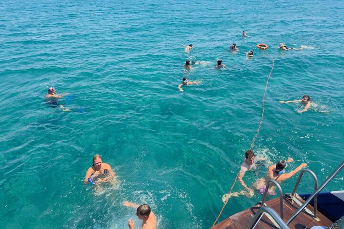 a group of people in the water on a boat