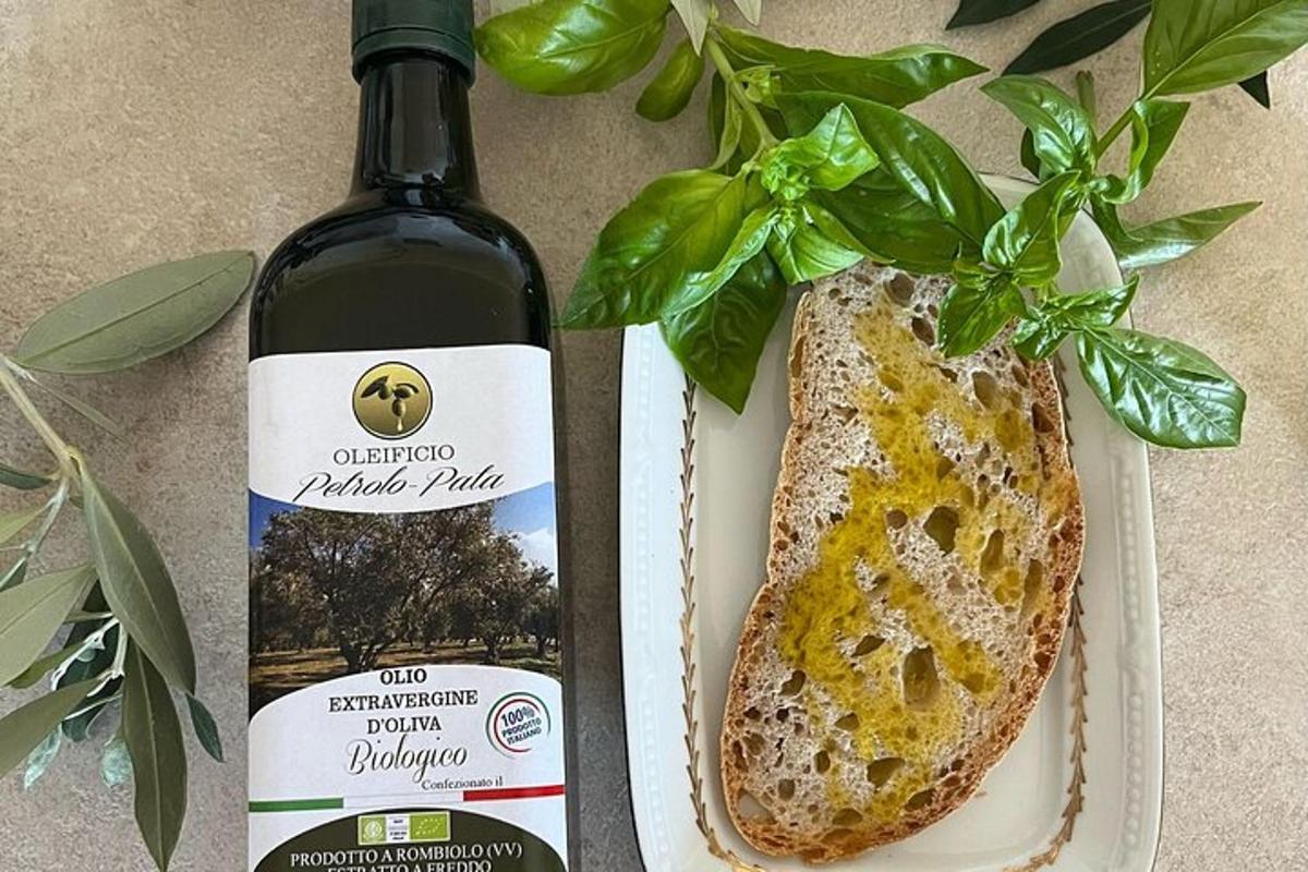 a bottle of wine next to a loaf of bread