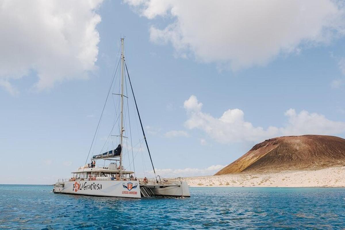 a boat in the water with a hill in the background