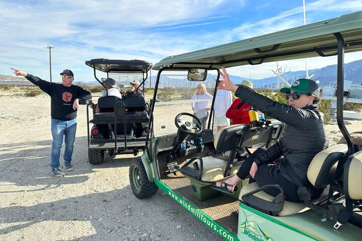 a group of people riding in a golf cart