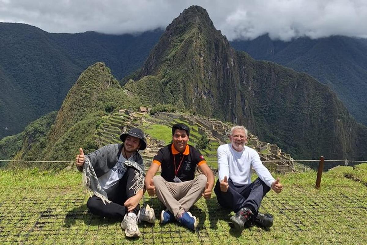 three men sitting on top of a mountain
