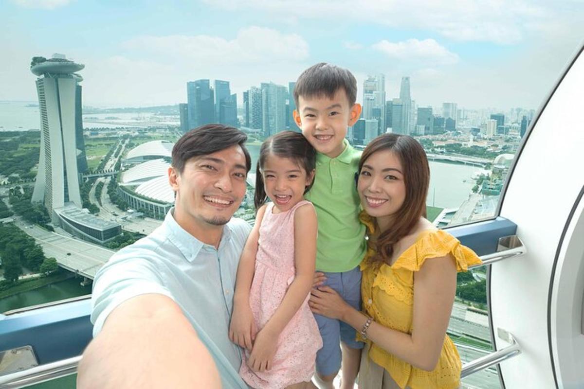 a family posing for a picture in the sky scrapper
