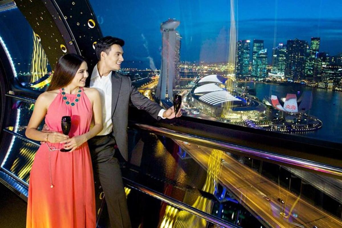 a man and a woman standing on top of a building