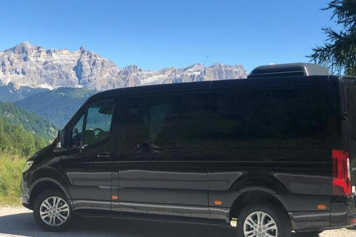 Una camioneta negra estacionada frente a una montaña