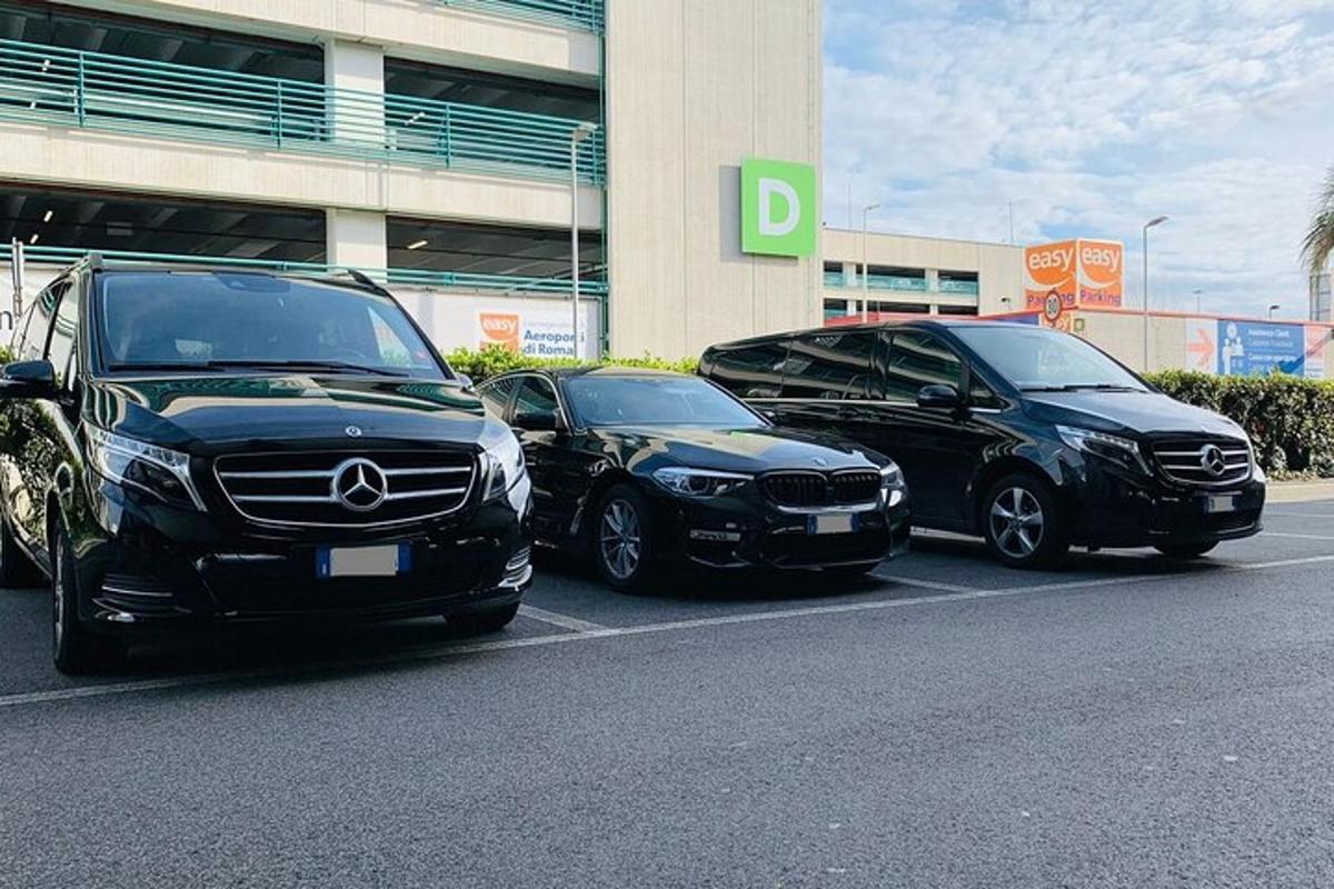 three cars parked in a parking lot in front of a building