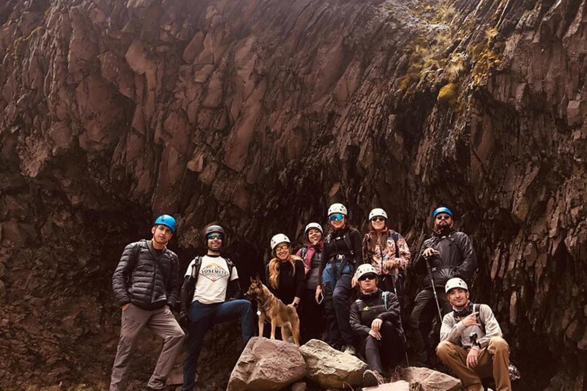 a group of people posing for a picture in front of a mountain