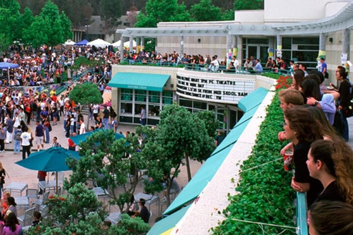a crowd of people standing outside of a building