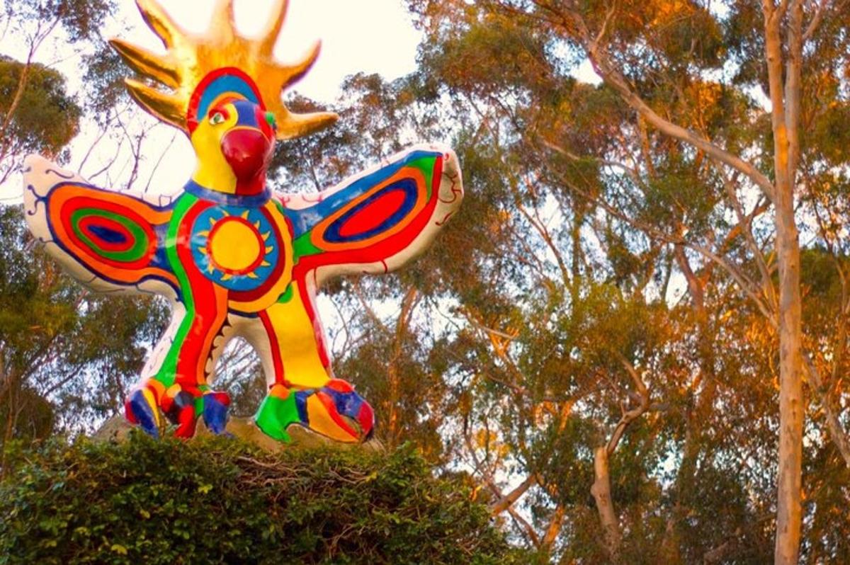 a large colorful kite sitting on top of a bush