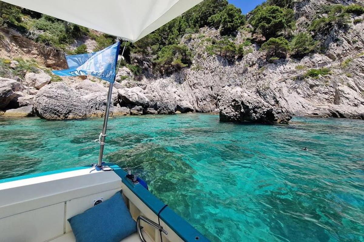 a boat in a body of water with rocks