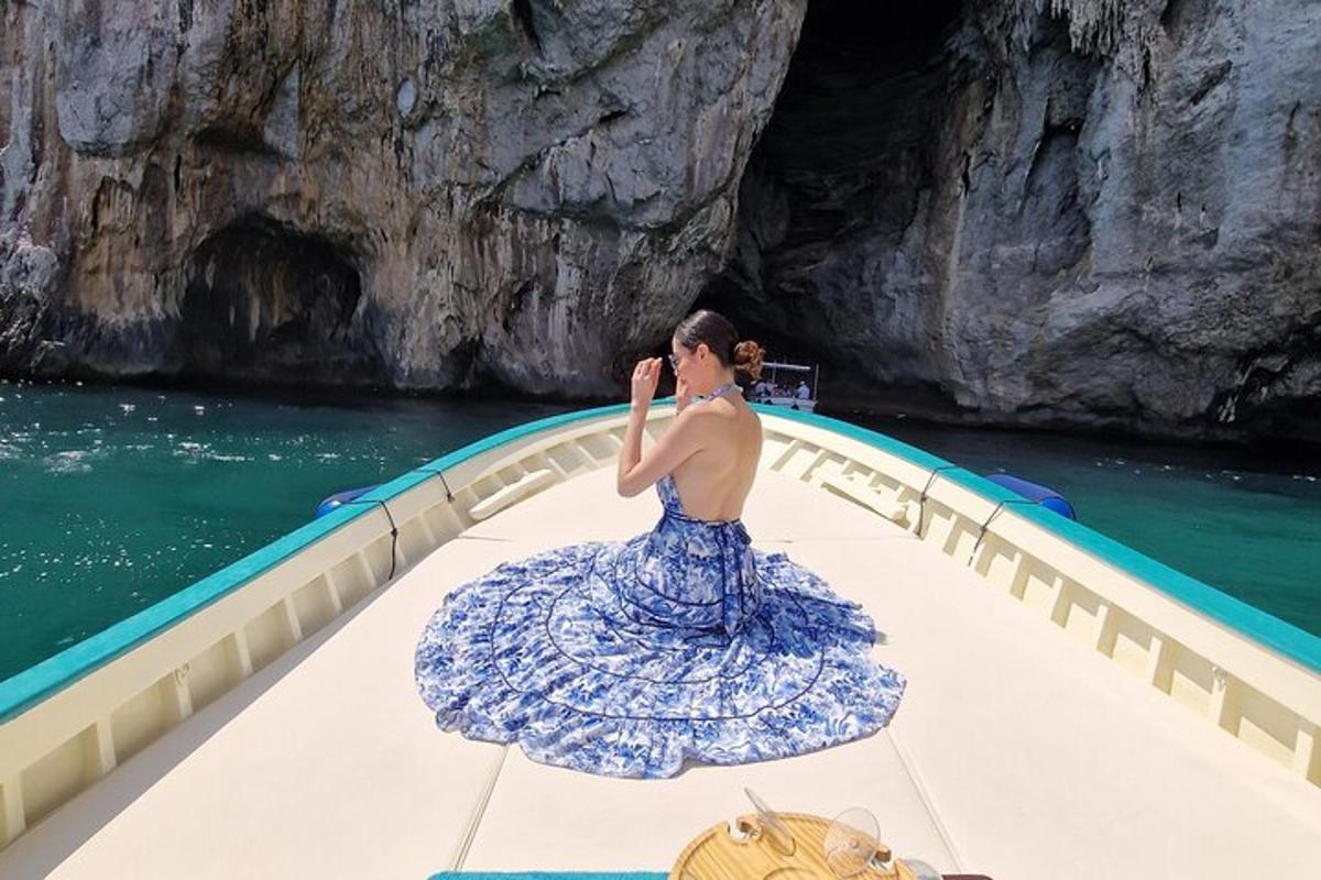 a woman in a blue dress on a boat in the water