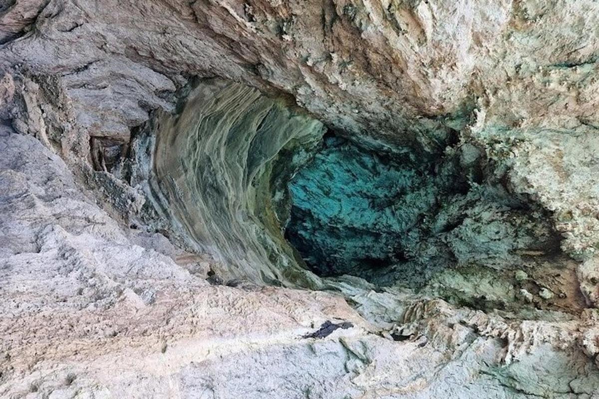 a cave in the side of a mountain with water