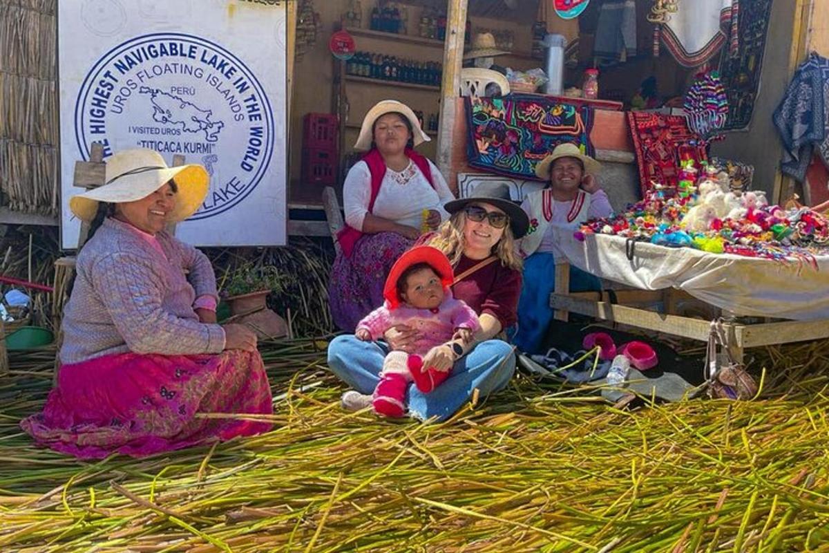 a group of women with a baby sitting on hay