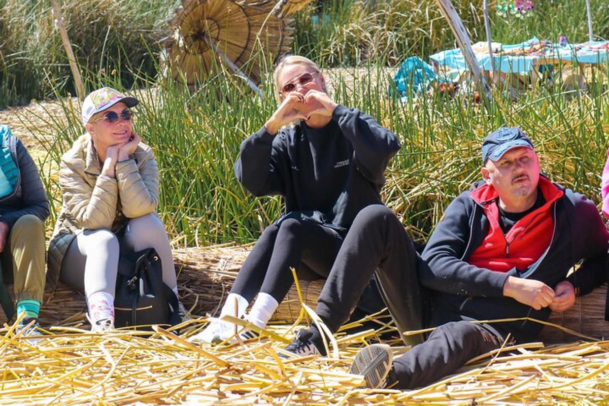 a group of people sitting on a pile of straw