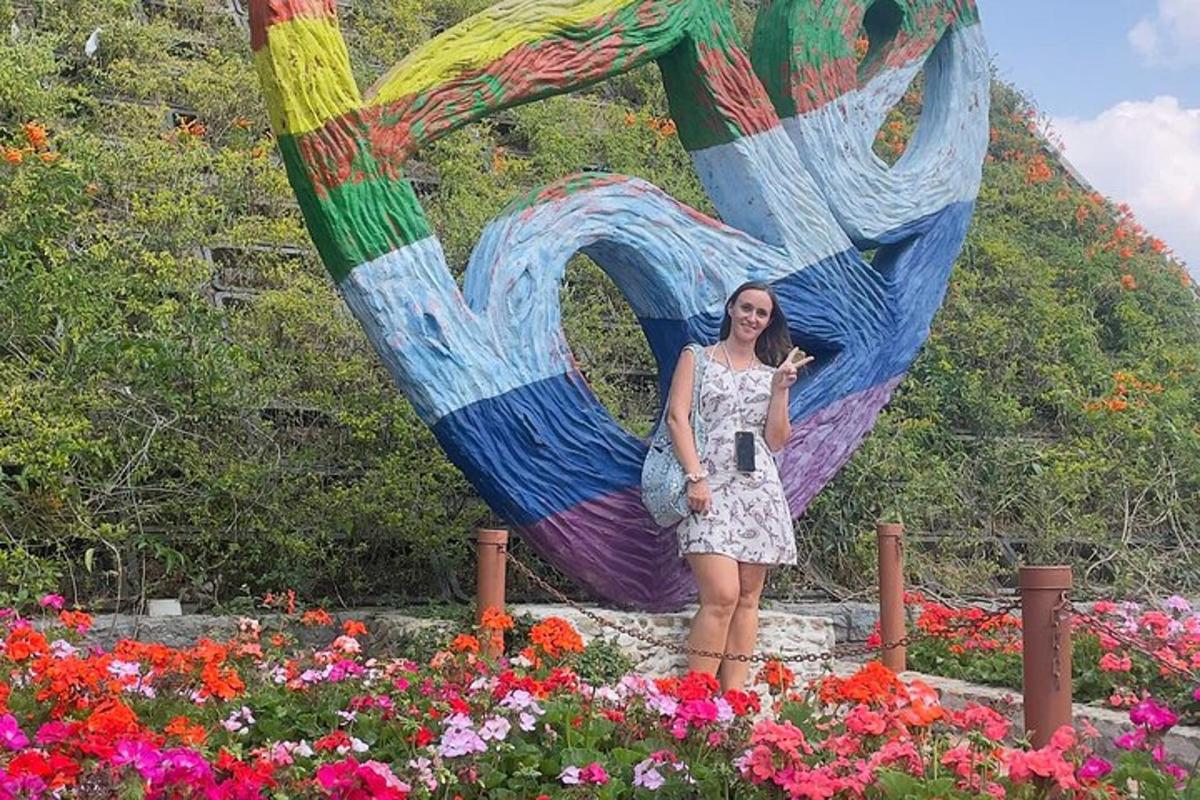 a woman standing in front of a large flower garden