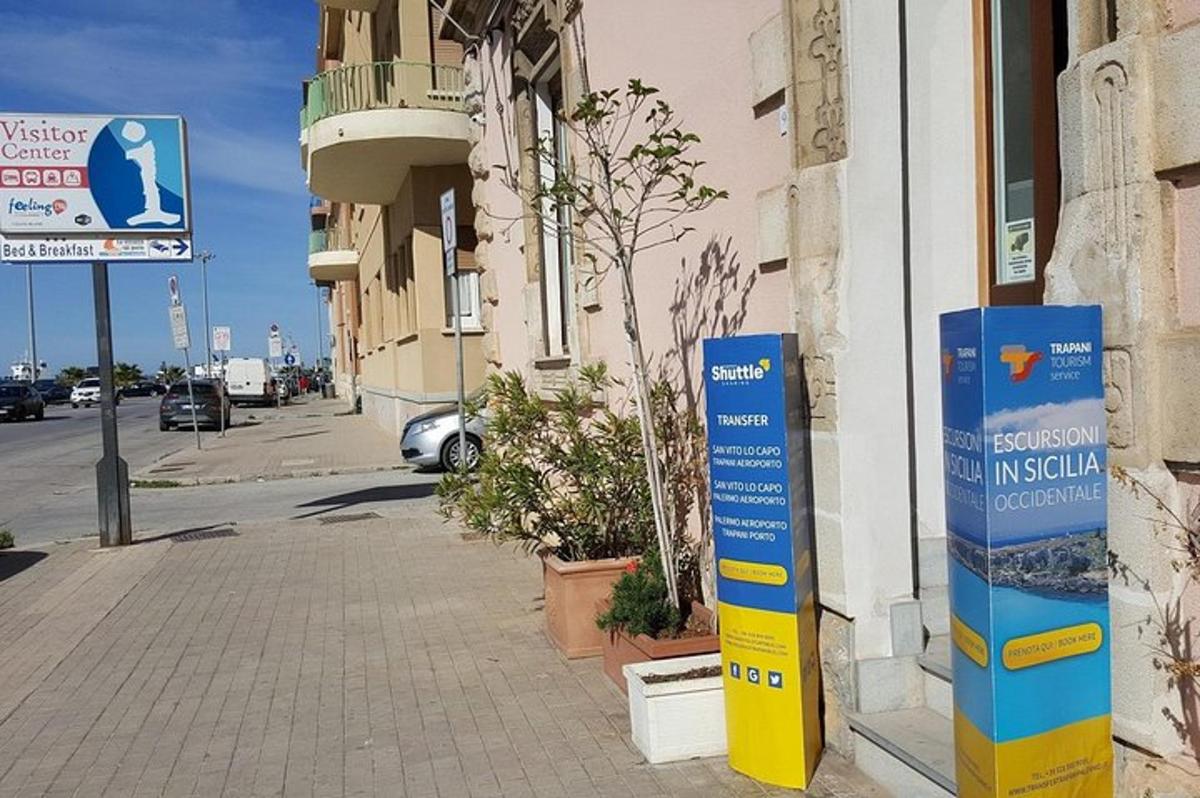 un cartello sul lato di un edificio su un marciapiede