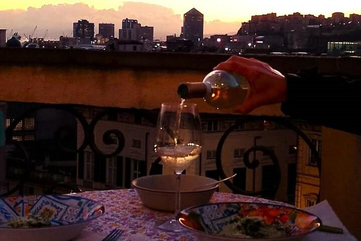 a person pouring wine into a wine glass on a table