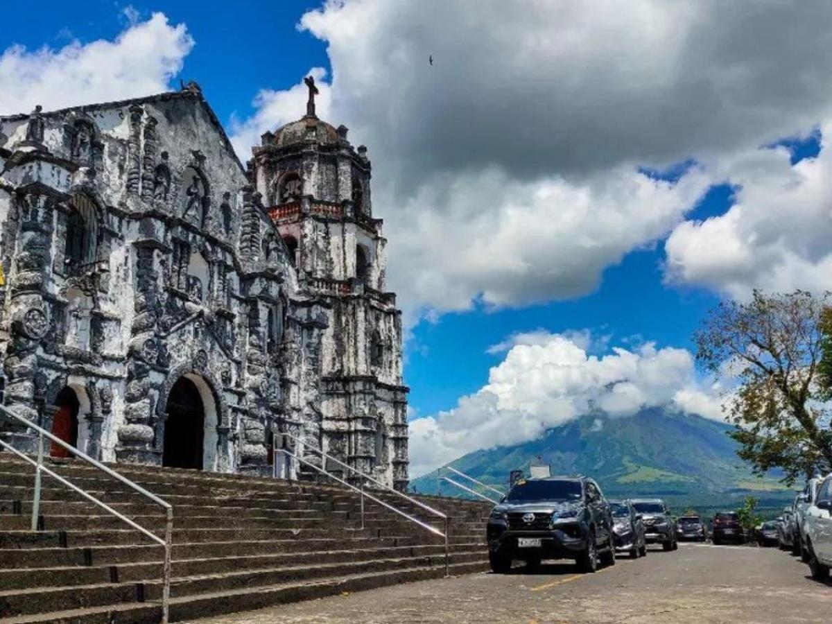 an old building with cars parked in front of it