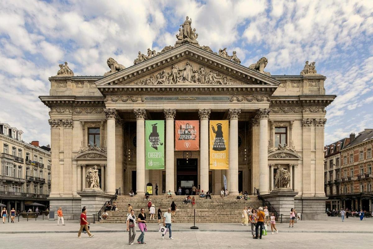 a large building with people walking in front of it