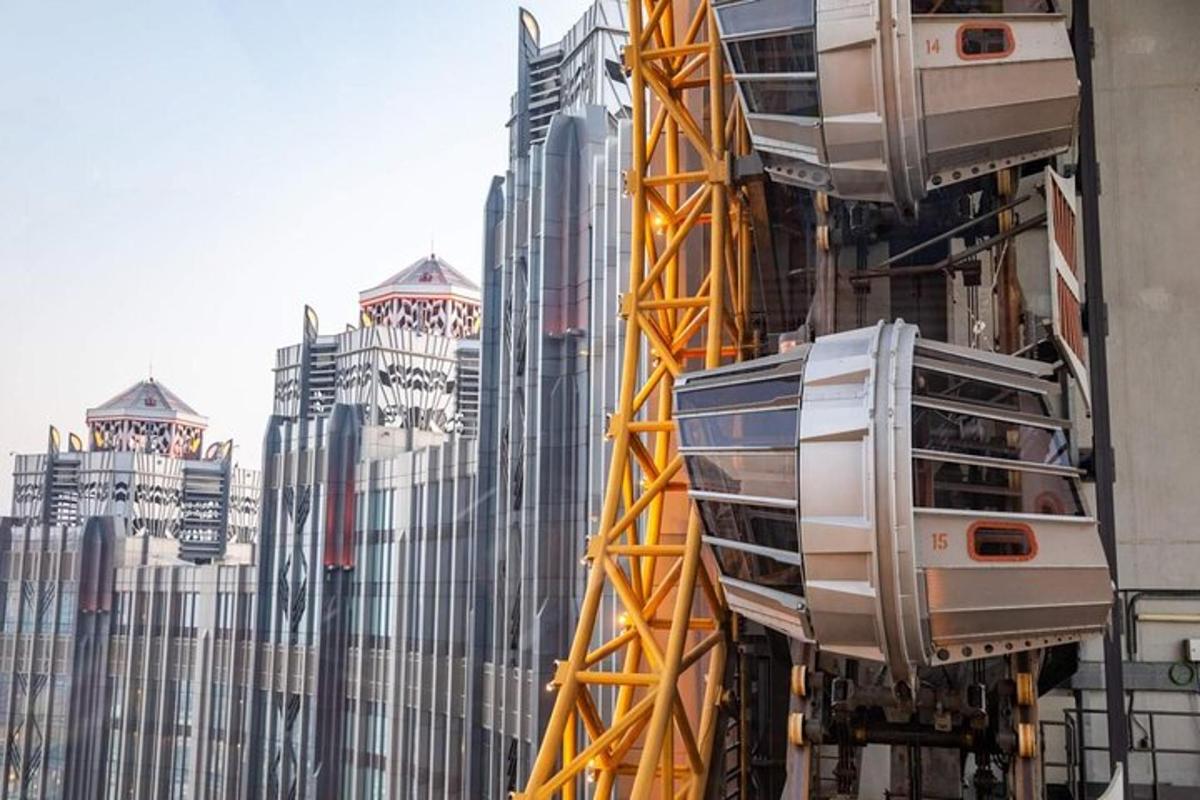 a tall building with a yellow crane in front of it