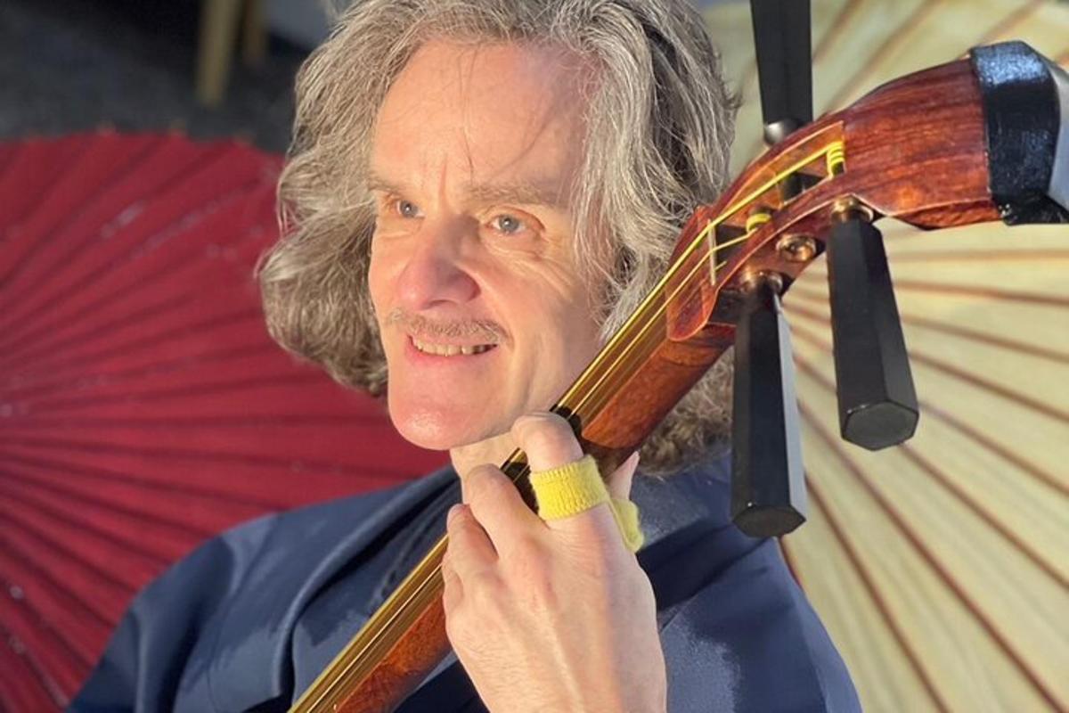 un uomo anziano tiene in mano un violino