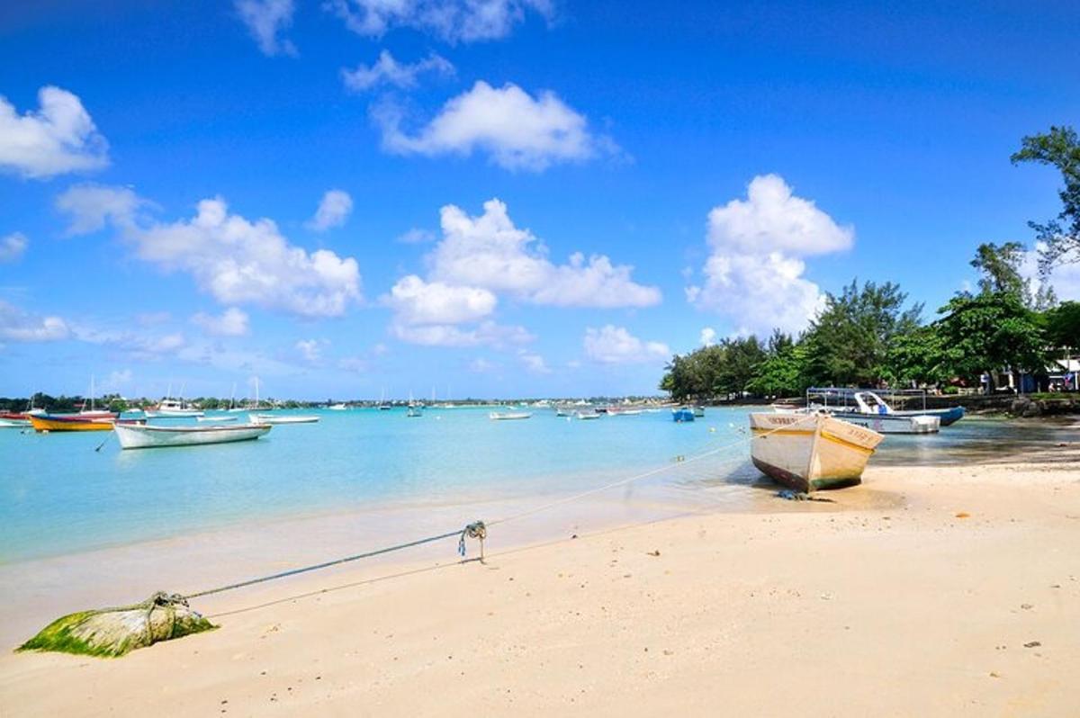 a beach with boats in the water on a sunny day