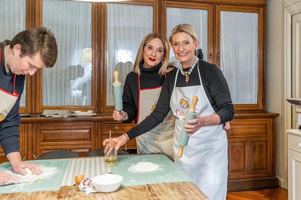 two women are standing in a kitchen preparing food