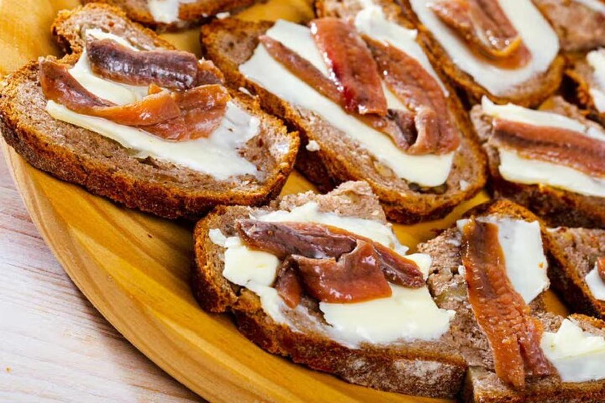 four slices of bread with bacon and cheese on a plate