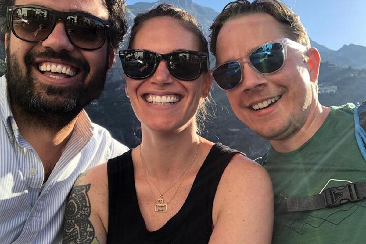 three people wearing sunglasses posing for a picture